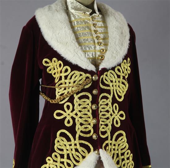Fledermaus: Prince Orlofskys maroon velvet jacket, trimmed with gold braid and white fur trim, a matching silver and gold waistcoat an